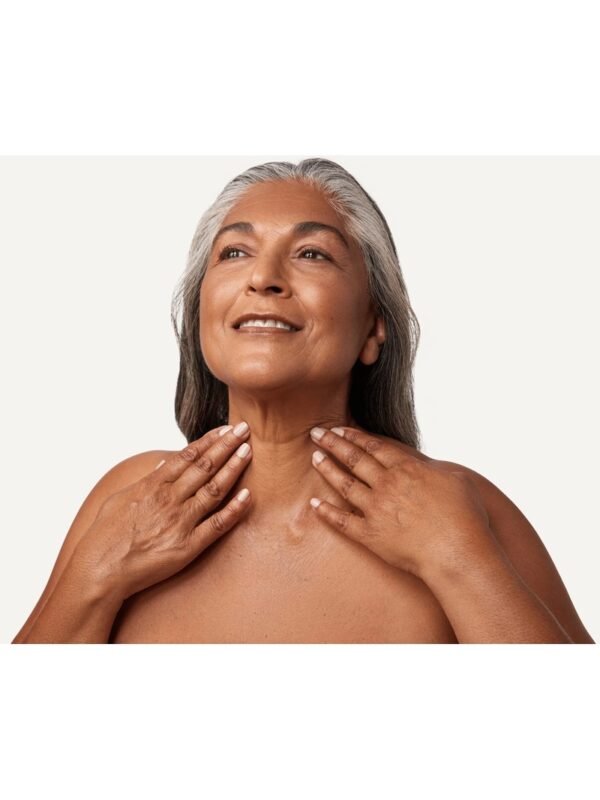 Boost Lab Edelweiss Neck Firming Serum – Lifestyle Model Mature woman with silver hair touching her smooth, firm neck after using Boost Lab Neck Firming Serum